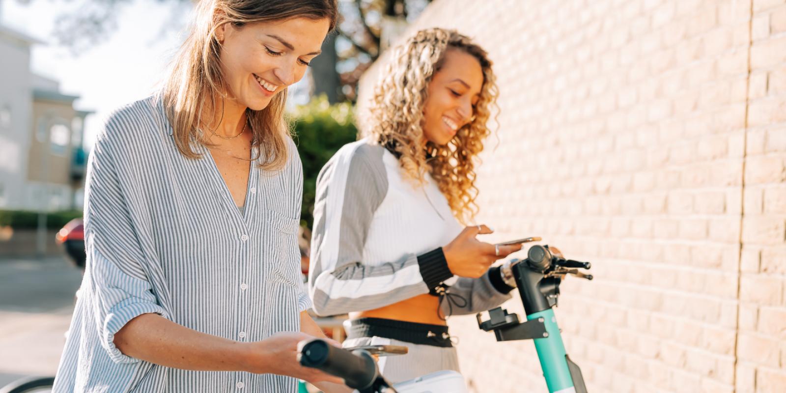Two young women unlocking their Beryl bikes
