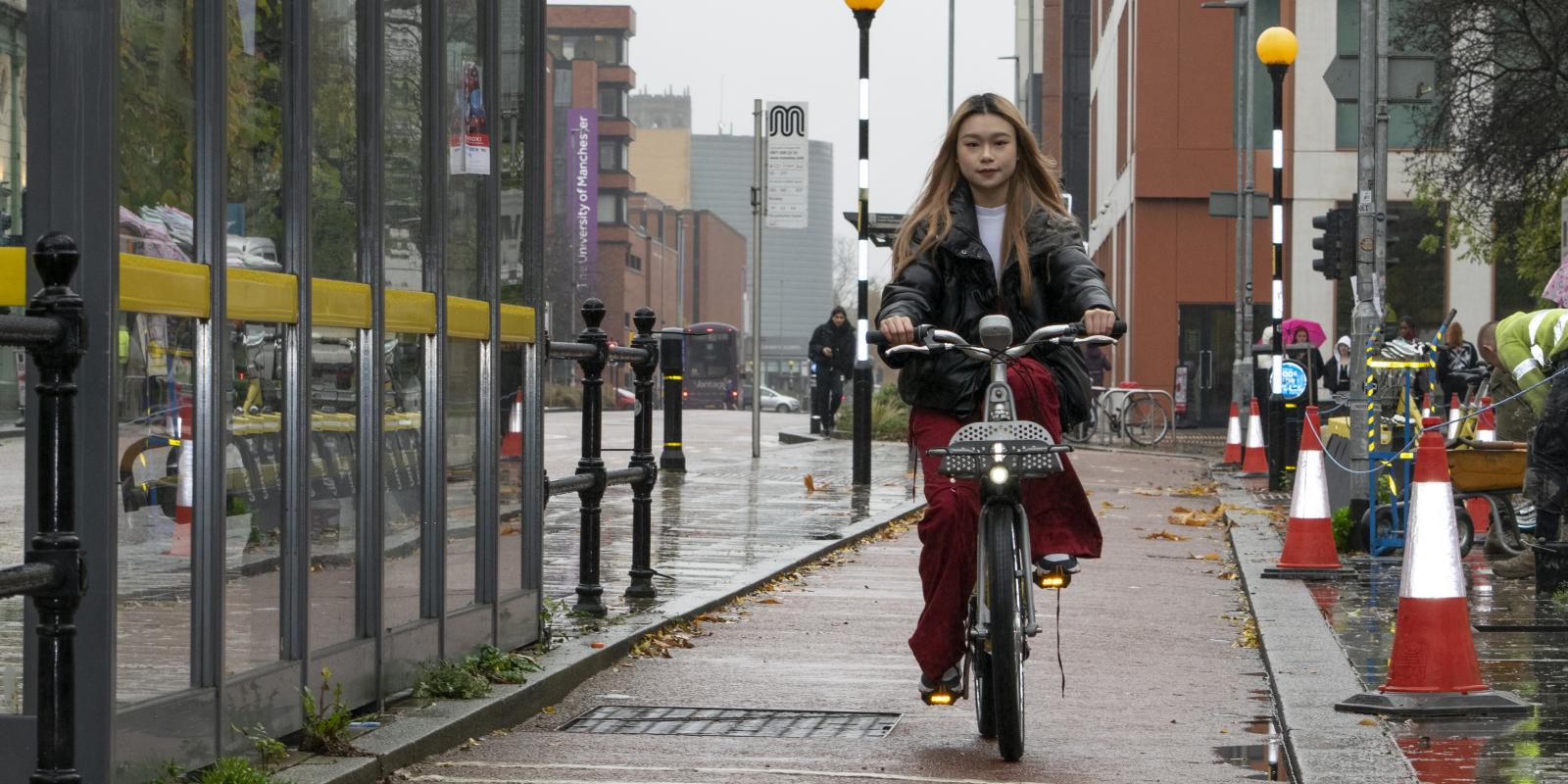 Rider using a Beryl bike on Oxford Road, Manchester