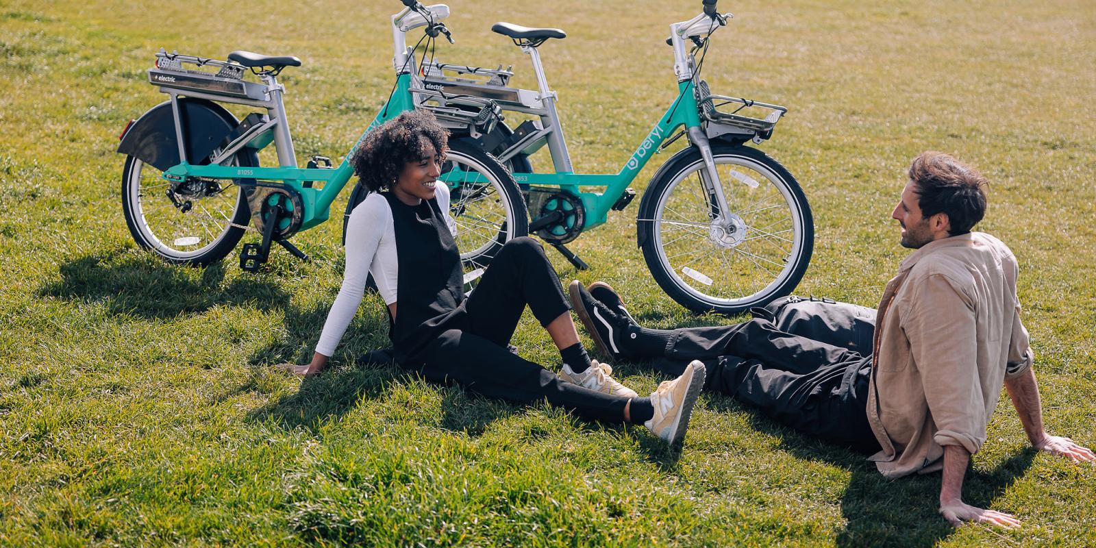 Beryl e-bike riders enjoying a break from riding on the grass