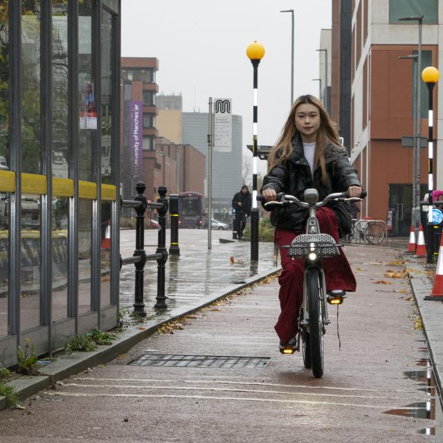 Rider using a Beryl bike on Oxford Road, Manchester