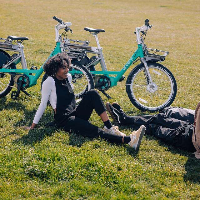 Beryl e-bike riders enjoying a break from riding on the grass