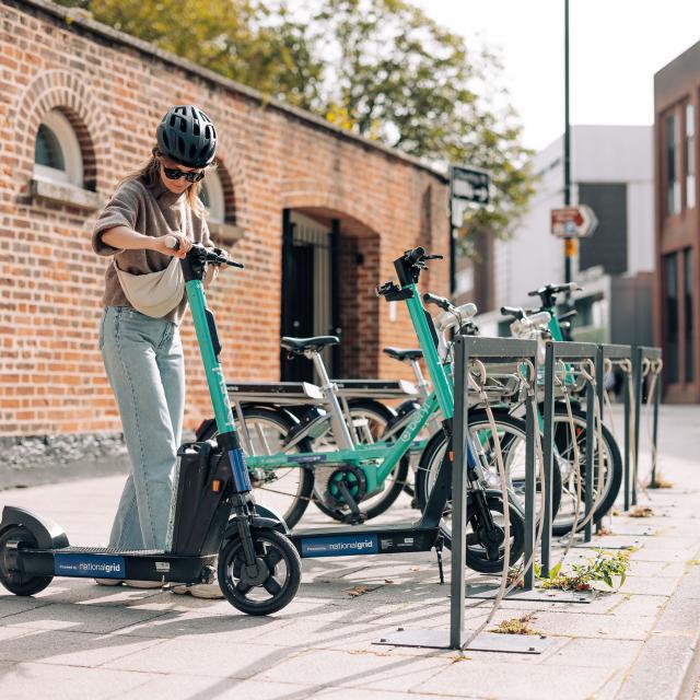 Beryl rider in Norwich about to end or start an e-scooter journey by some office buildings