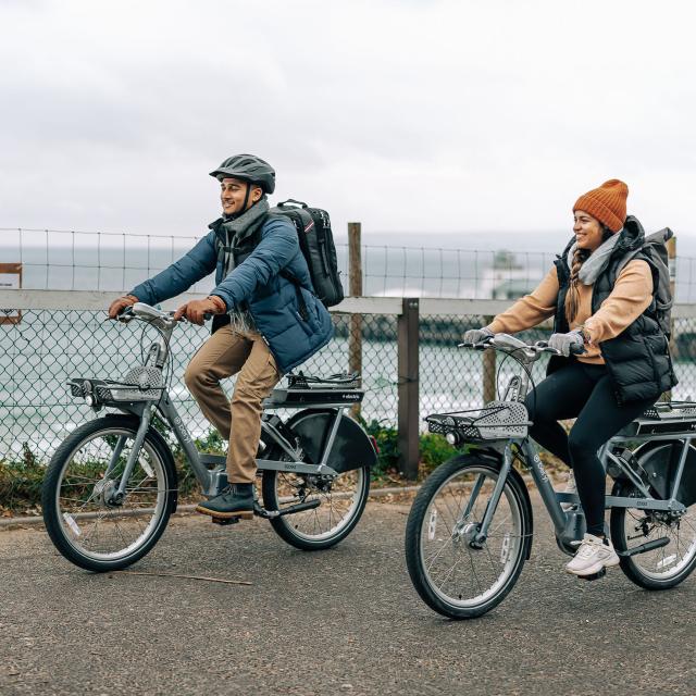 Two riders enjoying the Beryl e-bikes on Bournemouth front