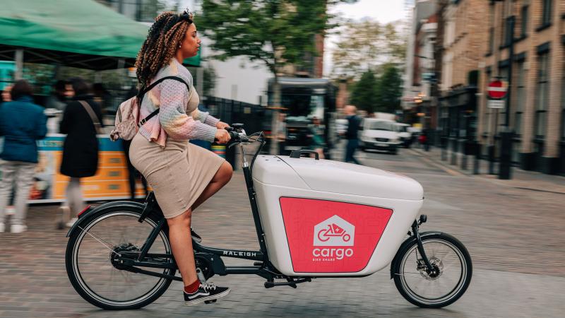 Woman riding Beryl cargo bike in London market
