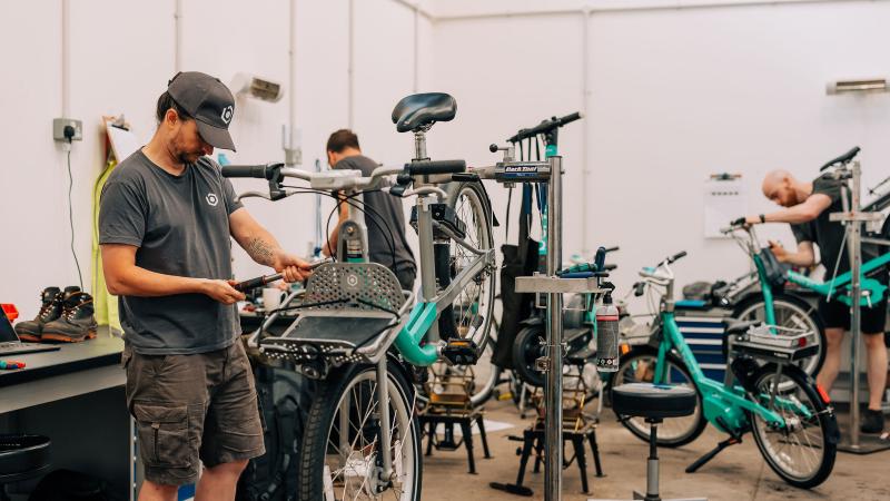 Beryl mechanics fixing Beryl bikes in workshop