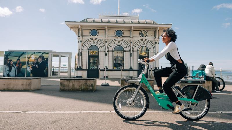 Woman cycling on Brighton promenade