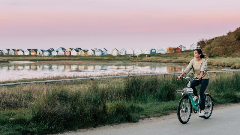 Rider enjoying a Beryl bike journey along the Bournemouth seafront 