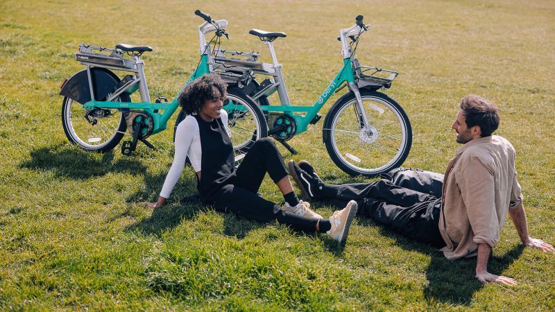 Beryl e-bike riders enjoying a break from riding on the grass