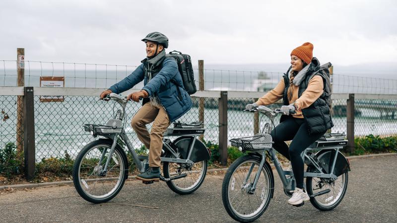 Two riders enjoying the Beryl e-bikes on Bournemouth front